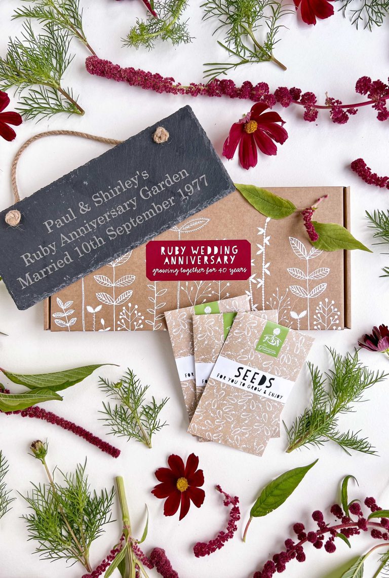 Ruby Wedding Anniversary seed box displayed with seed packets, personalised slate and red flowers from the seed box.