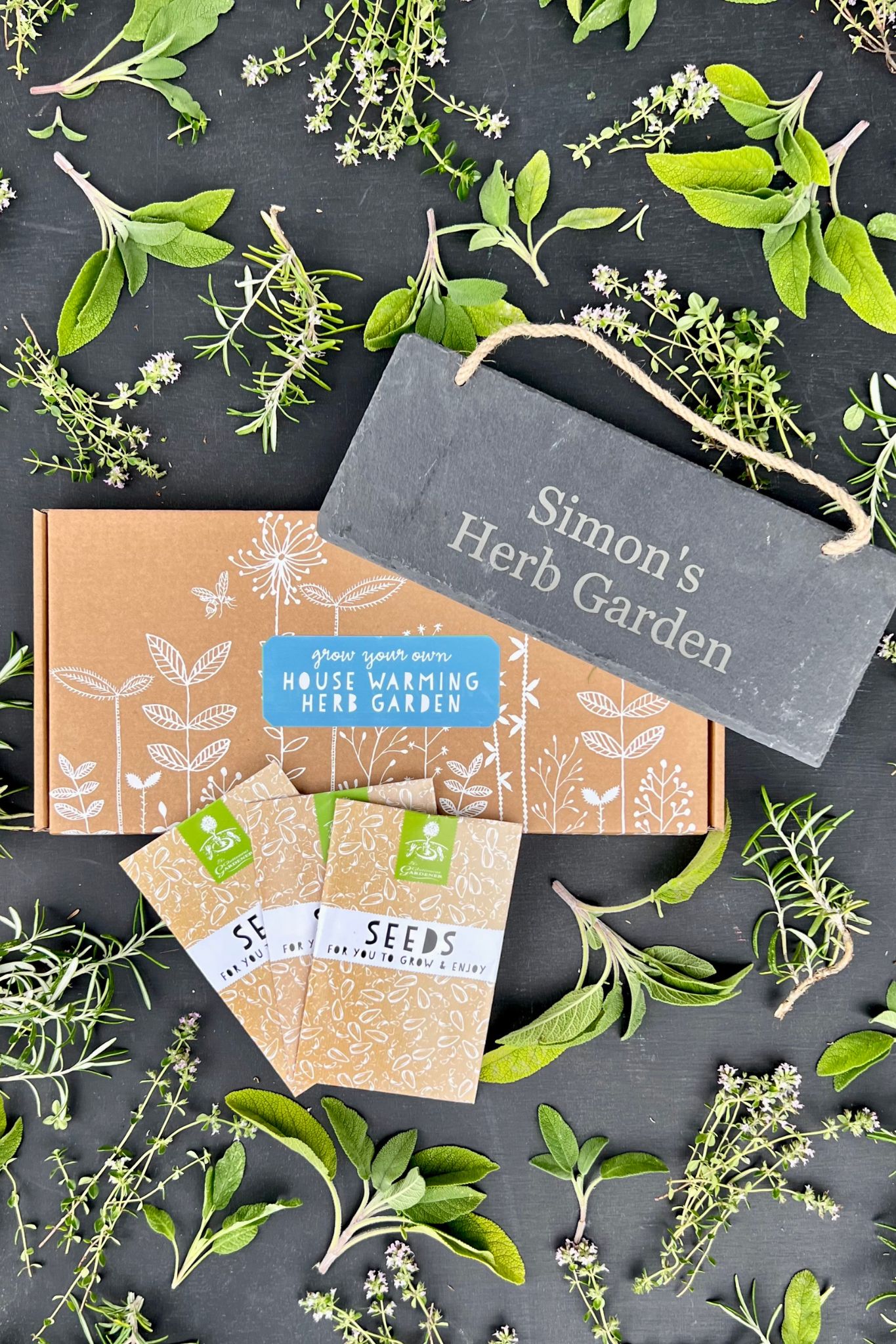 House Warming seed box with personalised slate and seed packets against black background.