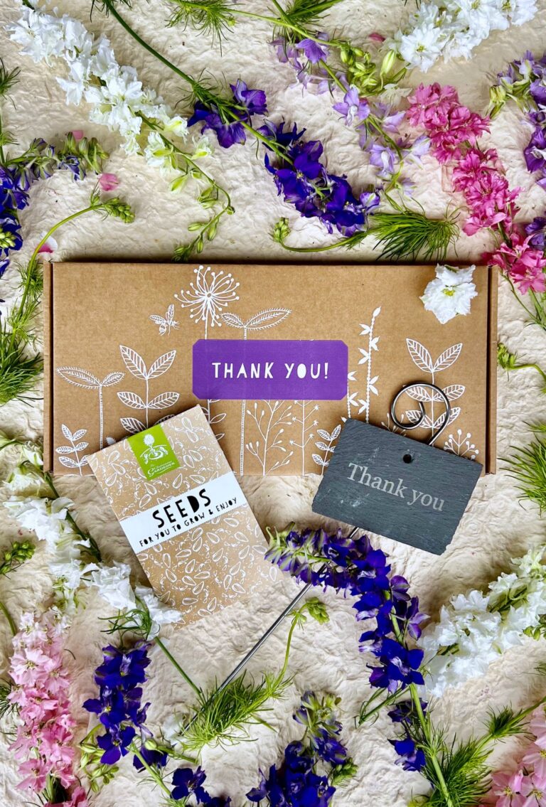 Thank You seed box displayed with seed packet, personalised slate and flowers from the seed box.