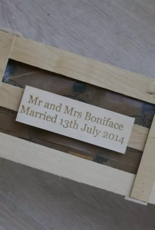 A wooden gift crate with a personalised wooden plaque that reads 