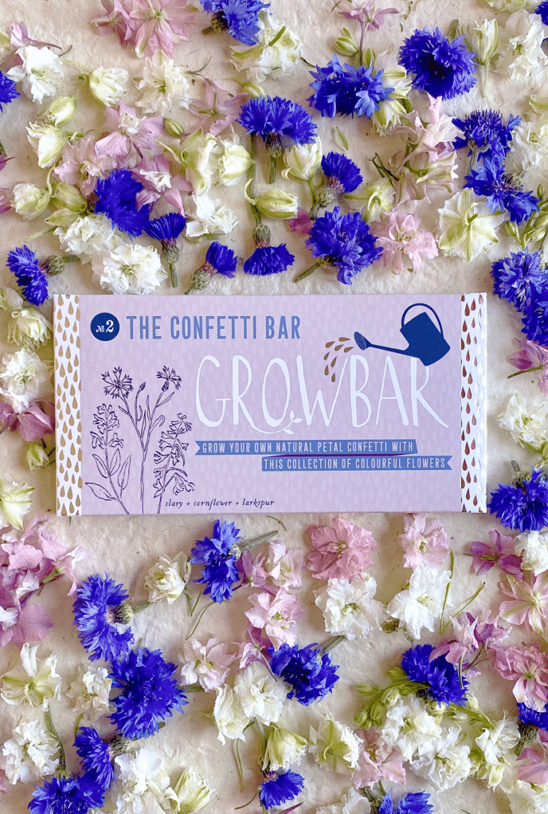 A lilac growbar to grow confetti surrounded by a sea of deep blue, pink and white flowers of Clary, Cornflower & Larkspur.