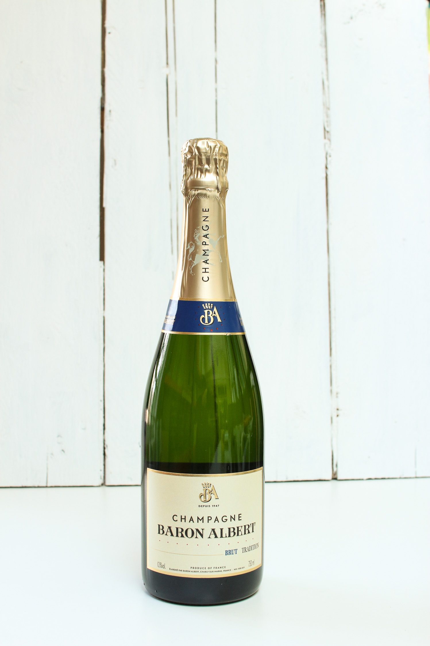 A green full sized bottle of champagne.