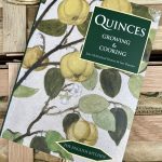 Close up of Quinces Growing & Cooking book on a wooden crate.