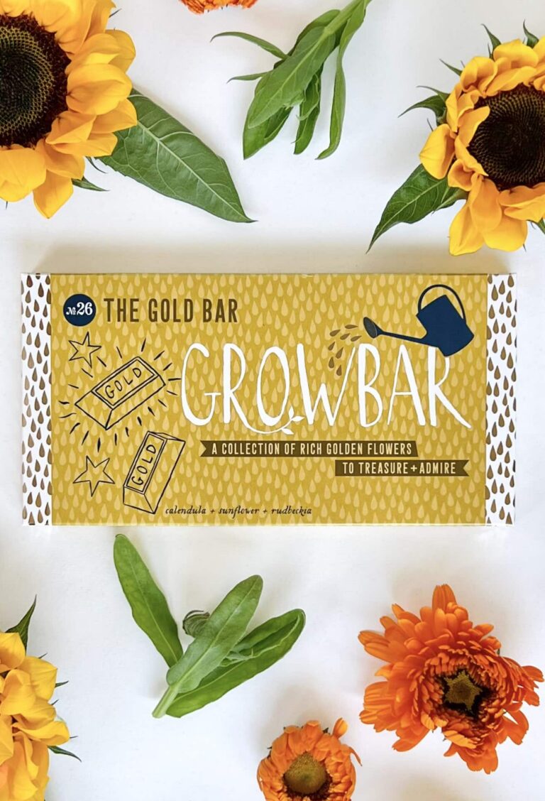 The Gold Bar against a white background displayed with vibrant orange and yellow flowers from the bar.
