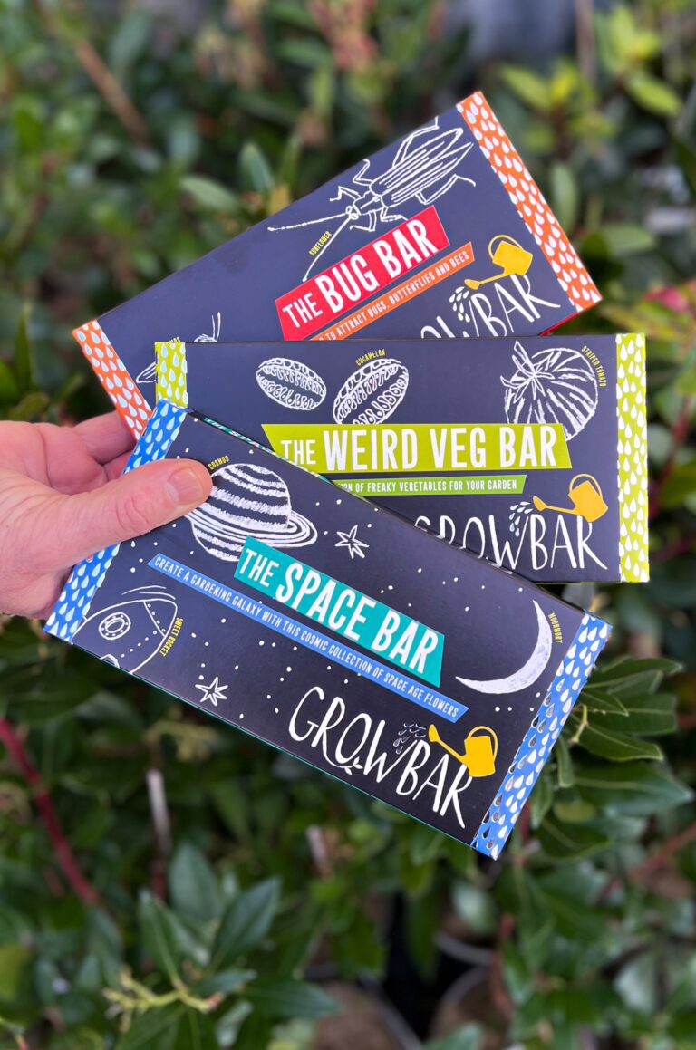 The kids bundle of growbars including the bug, weird veg and space bar in front of a background of plants