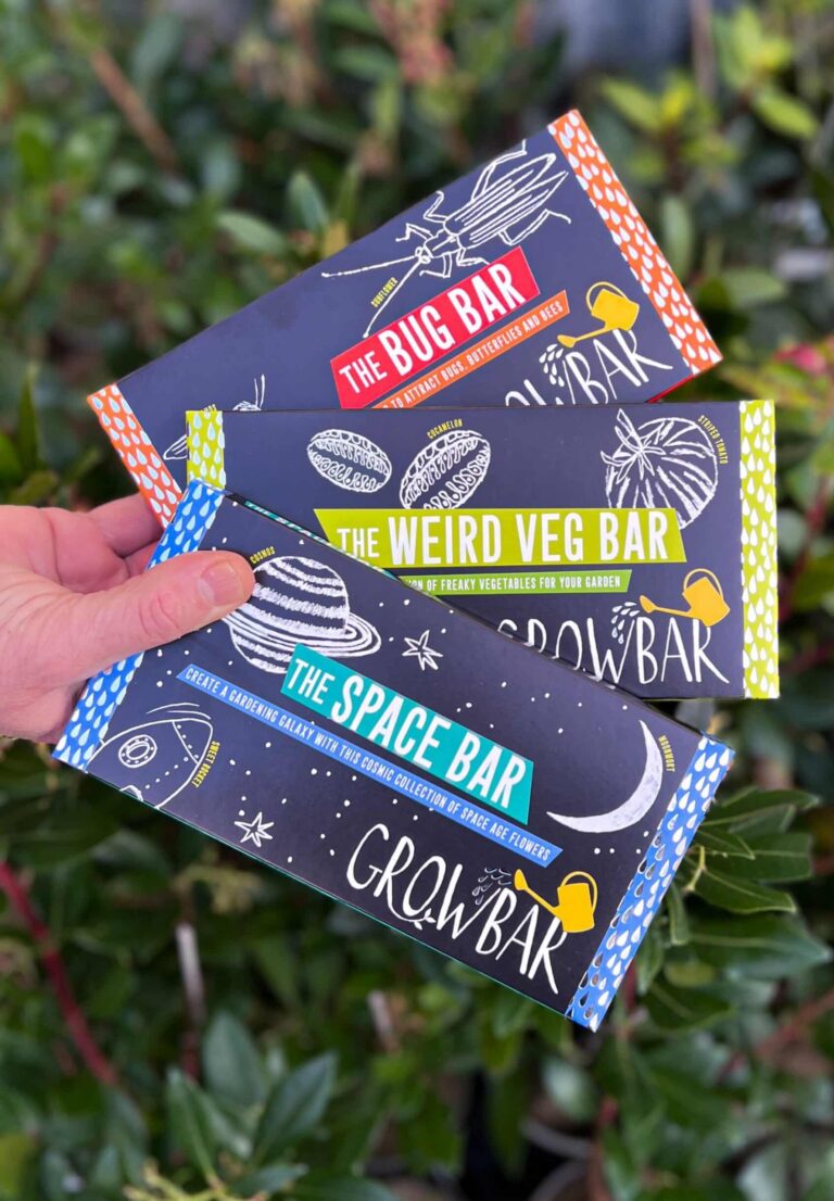 The kids bundle of growbars including the bug, weird veg and space bar in front of a background of plants